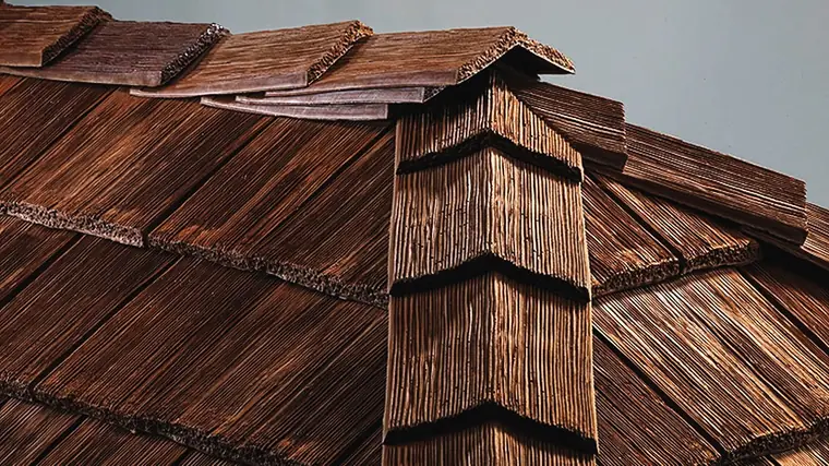 CeDUR synthetic cedar shake wrapping a roof hip, showing how the shakes are cut and stacked to turn the corner
