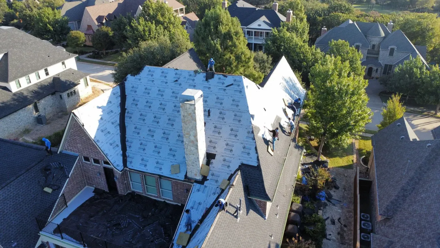 Aerial view of a full roof tear-off and replacement in progress
